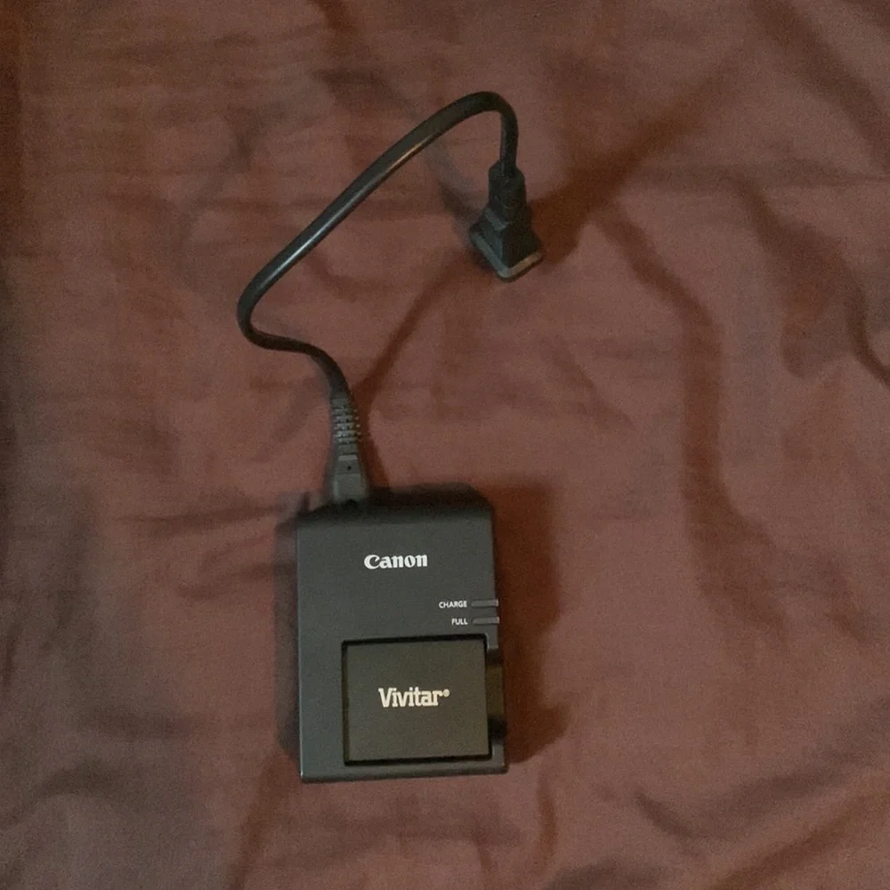 Selling a Canon Rebel T100 Camera with a lot of accessories and a backpack.